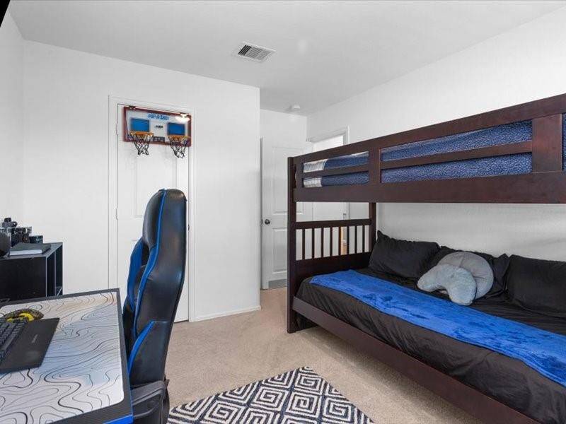 Secondary Bedroom 1 is bright and inviting, offering plenty of space for a bed and personal touches. Plus, the furniture in this room is included with the sale of the home, making it even more move-in ready.