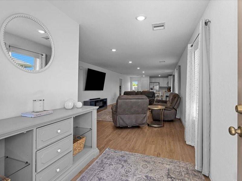 Step inside and you're immediately welcomed by a beautiful view of the family room — a warm and open space perfect for relaxing or entertaining
