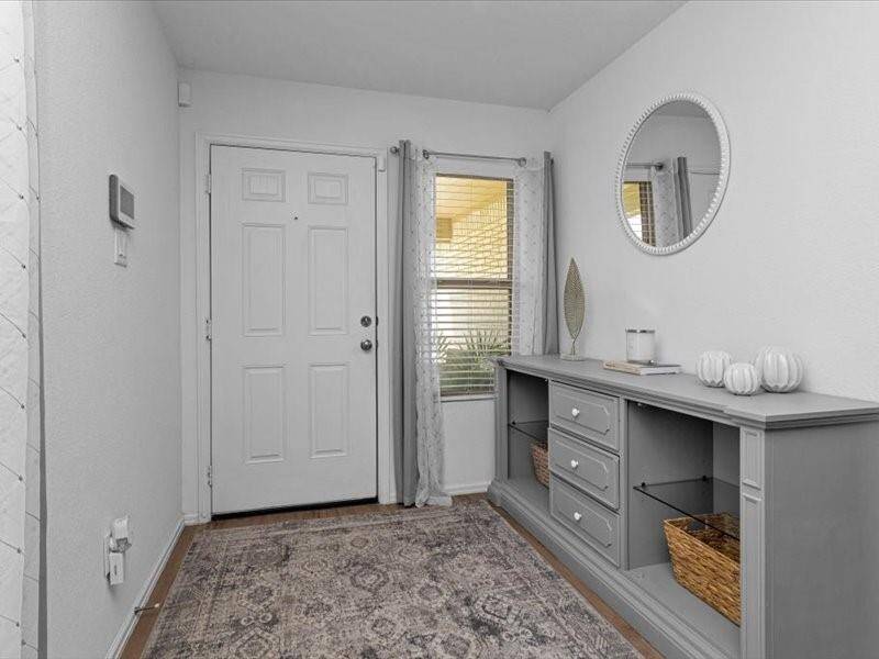 A front entry window fills the space with natural light, creating a bright and welcoming first impression.