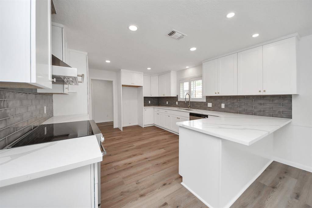 The on-trend gray backsplash and modern lighting add a polished, contemporary finish.