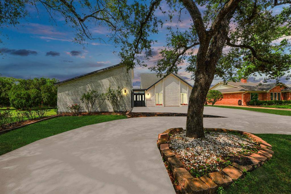 Set on an oversized lot with a stately circular drive, this beautifully updated home offers timeless curb appeal.