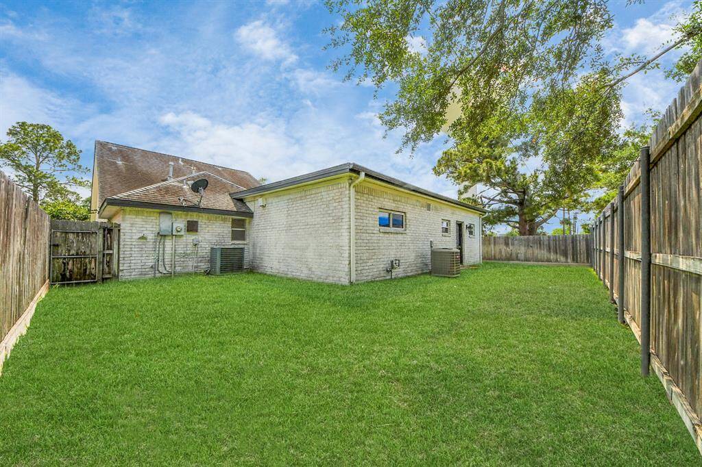 The private side yard offers a generous expanse of green space—ideal for pets, play, or future gardening.