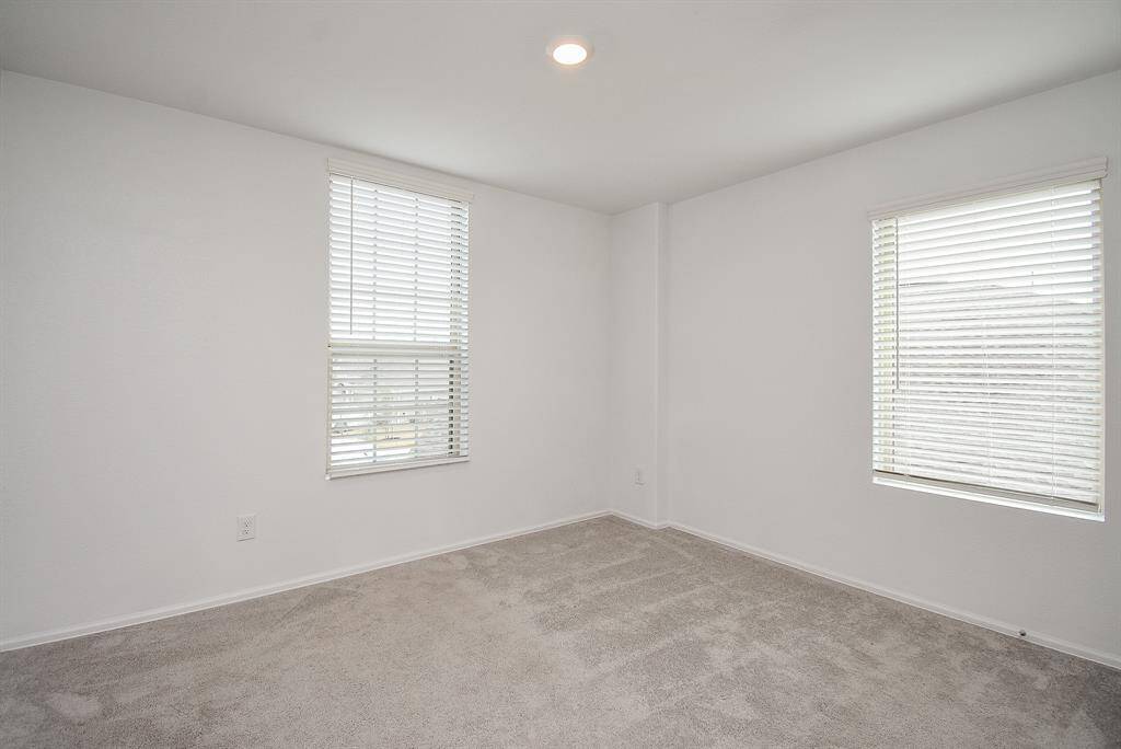Spacious bedroom with a modern, pristine design.