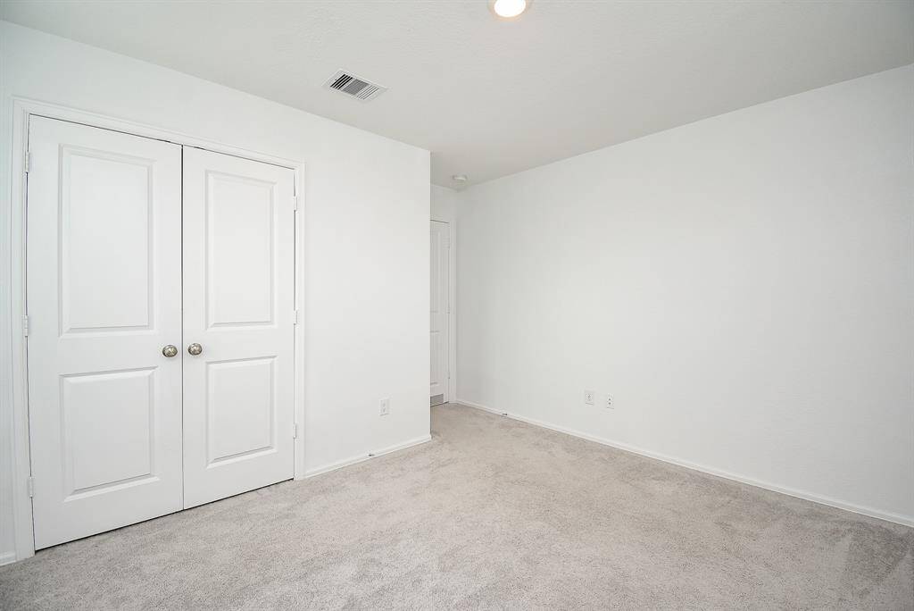 Spacious double-door closet for ample storage.