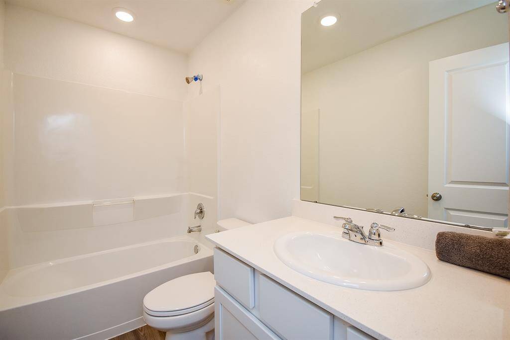 Upstairs pristine white bathroom with modern fixtures.