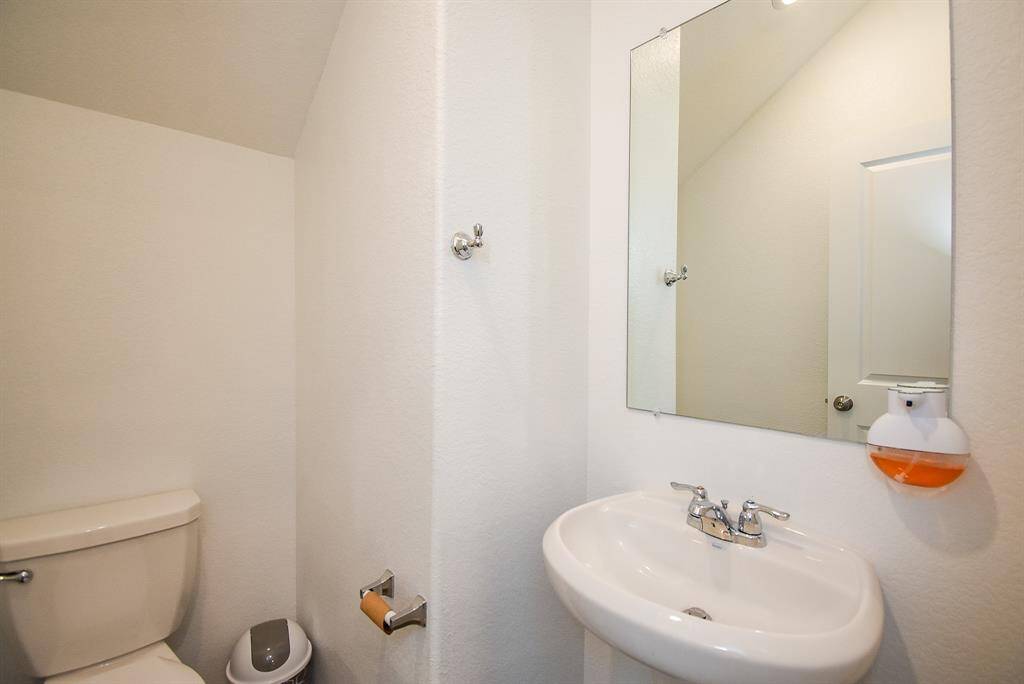 Cozy half bathroom with modern fixtures, perfect for guests.