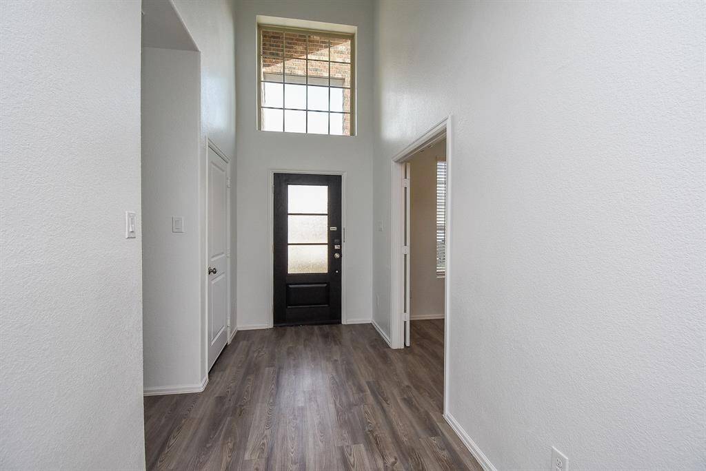 Welcome home to a bright entrance with soaring ceilings, offering an inviting and spacious feel.