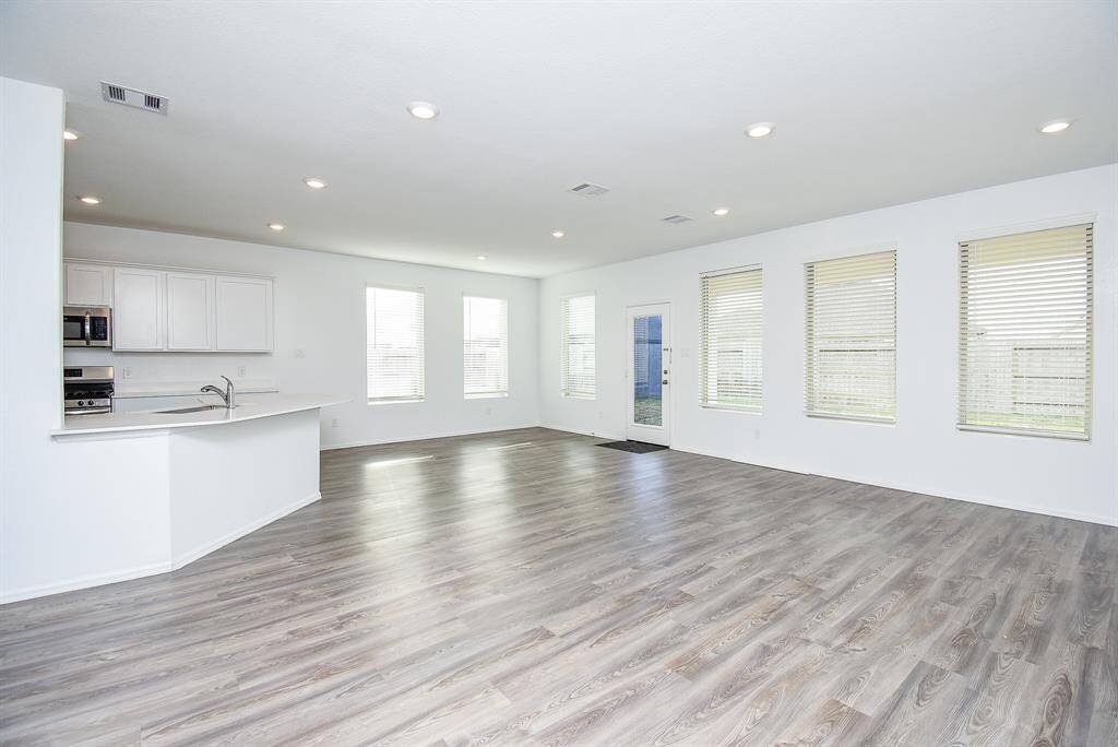 Expansive living room seamlessly flows into the kitchen and breakfast area.