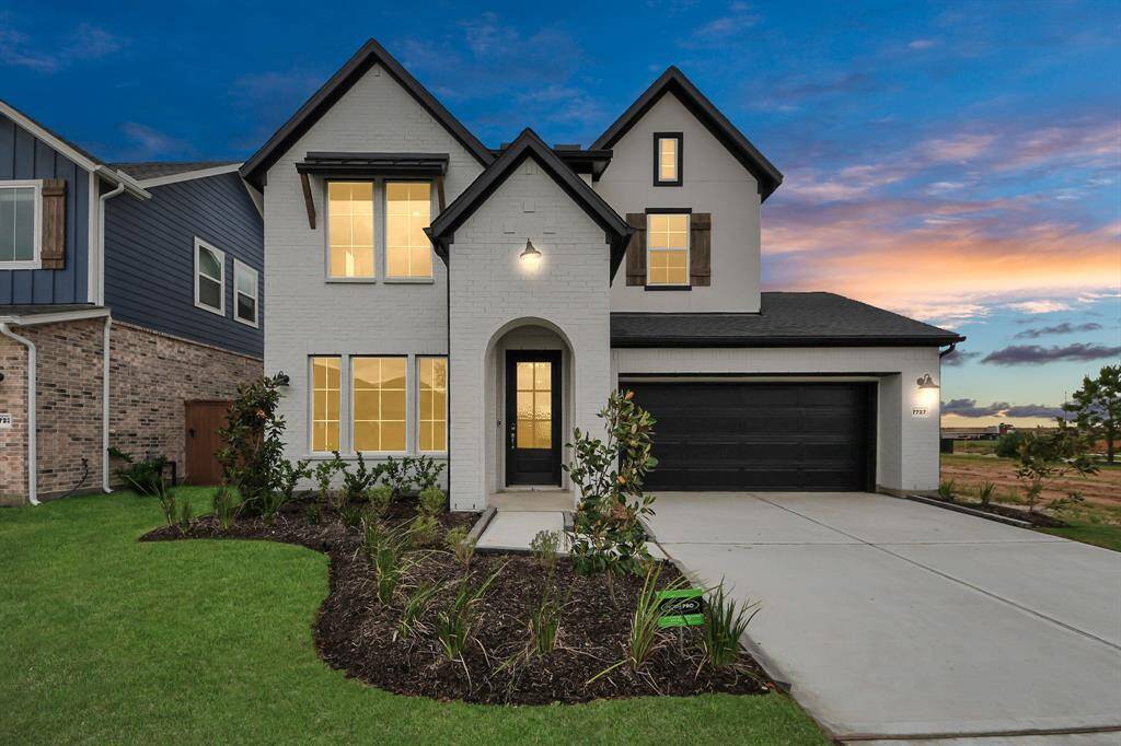 Discover this stunning modern two-story home with a sleek white exterior, dark trim, and a spacious two-car garage. Enjoy the beautifully landscaped front yard and breathtaking sunset views.