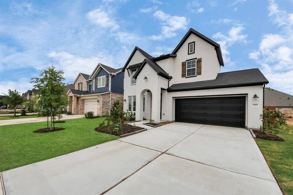 Discover this stunning modern two-story home featuring a chic black and white exterior, a spacious two-car garage, and a beautifully maintained front yard. Nestled in a charming suburban neighborhood with similar elegant homes.