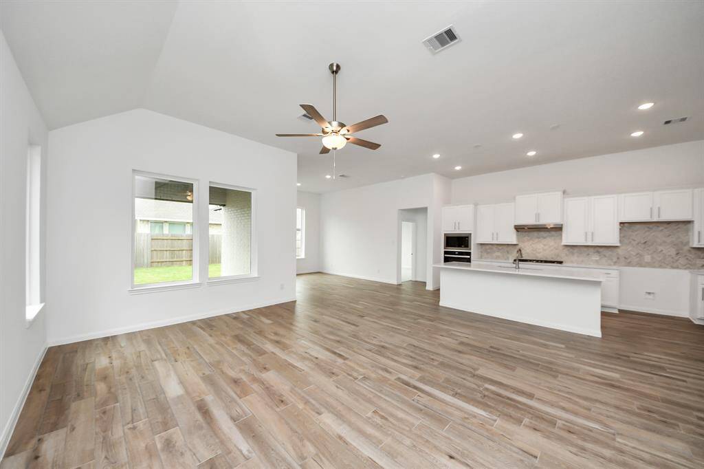 Delightful home with a spacious backyard, covered patio, and pristine lawn, ideal for entertaining and outdoor fun.