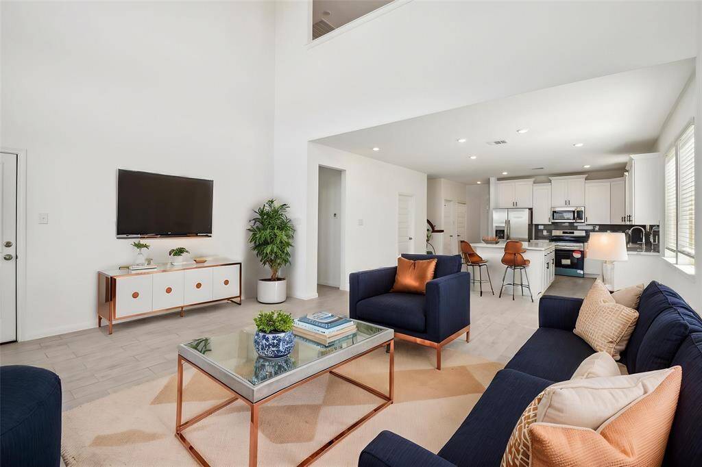The neutral color palette and abundant natural light enhance the contemporary feel of the home.