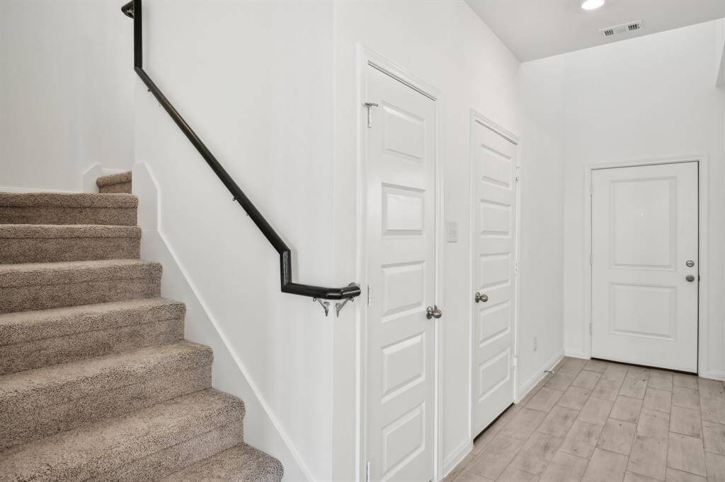 Discover this inviting entryway and the staircase that leads to the upper level.