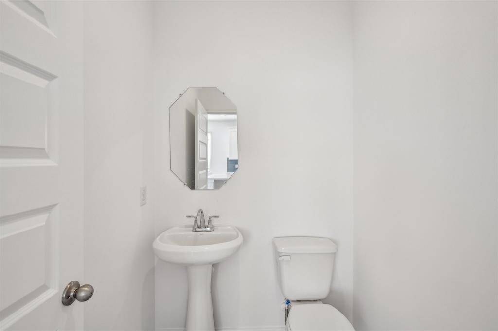Discover this crisp and clean white half bathroom.