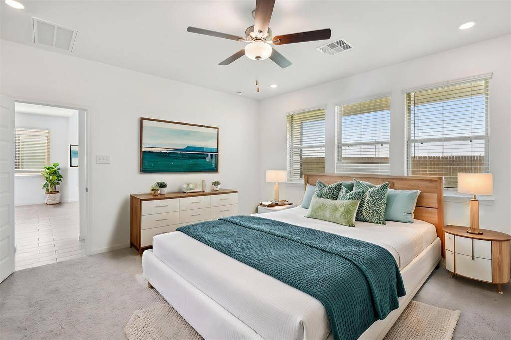 The large windows allow for plenty of natural light, while the ceiling fan provides added comfort.