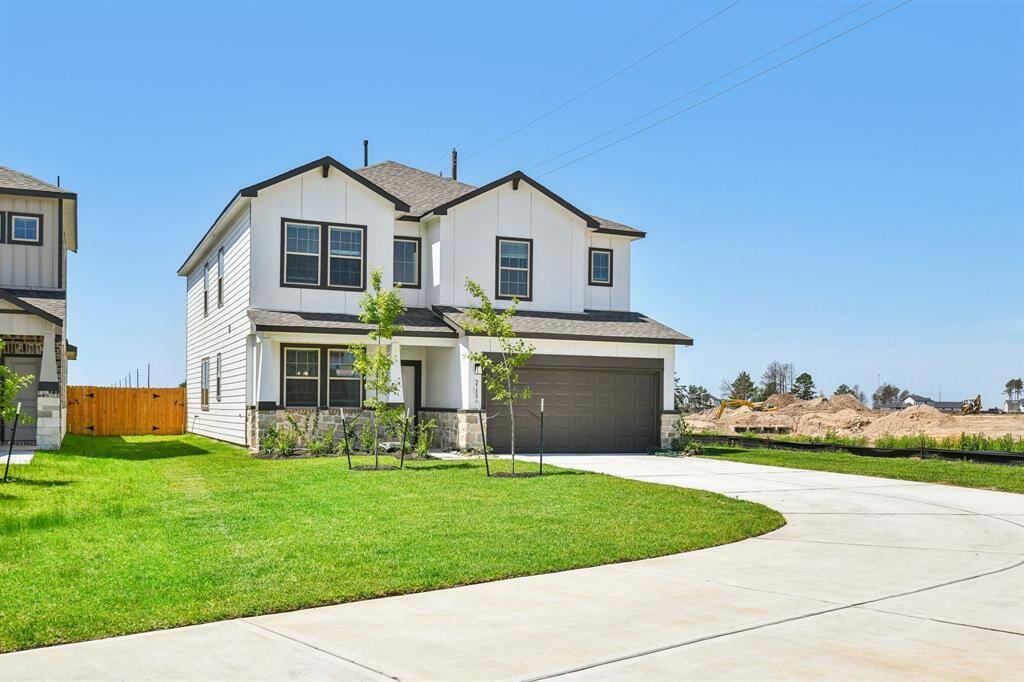 The long driveway and two-car garage offer ample parking perfect for guests.