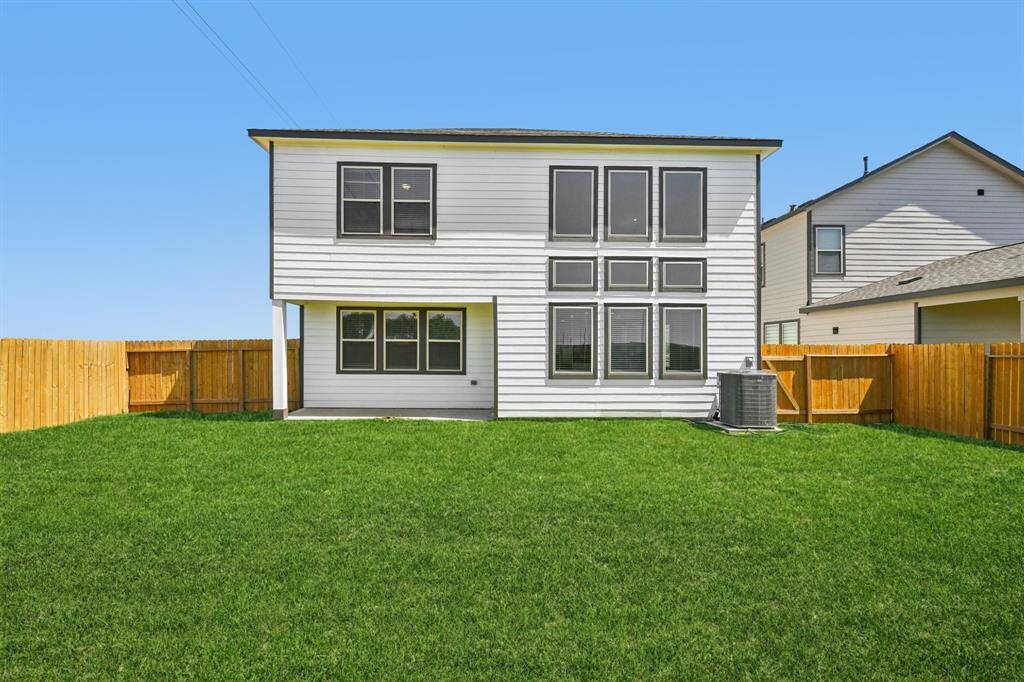 The gorgeous back view of the home, and fully fenced for privacy.