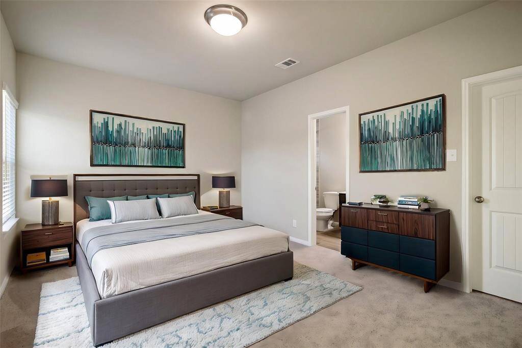 Step into the bathroom with glass-enclosed shower, and a spacious countertop.