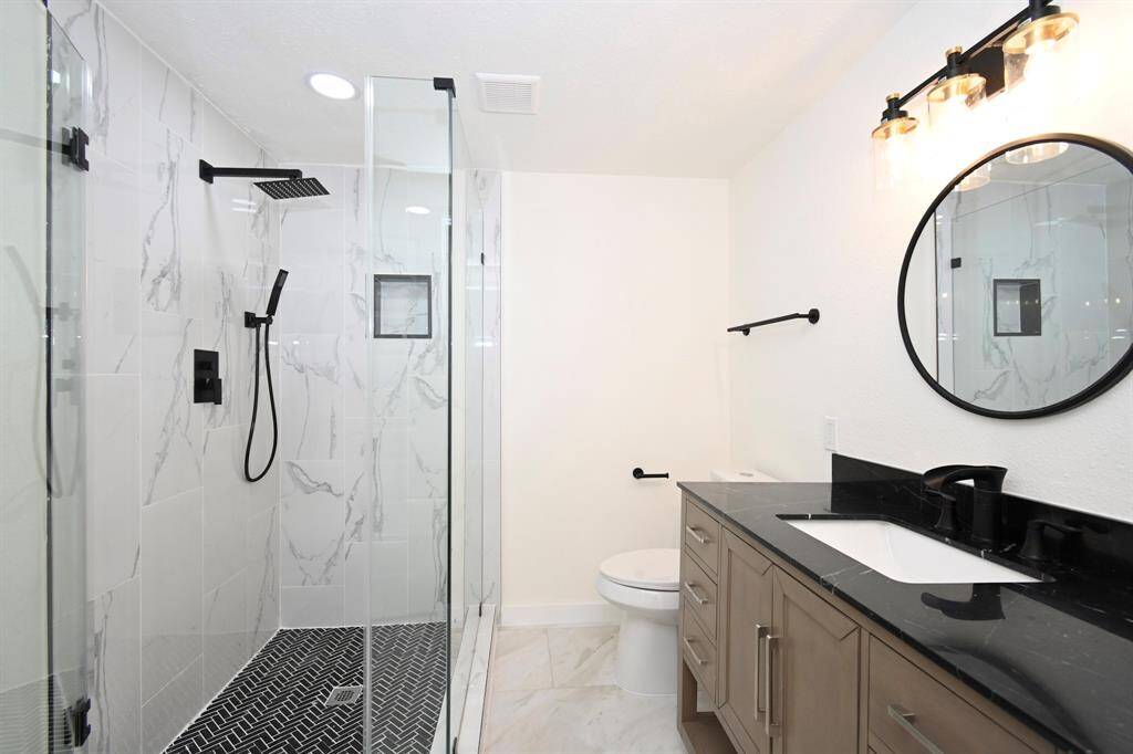 New Standing shower w/Glass doors, New mirrors, New light fixtures, New granite countertop Cabinets