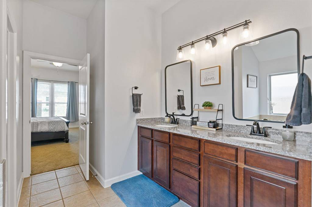 Spacious primary bath seamlessly connects to the inviting bedroom, offering comfort and convenience.