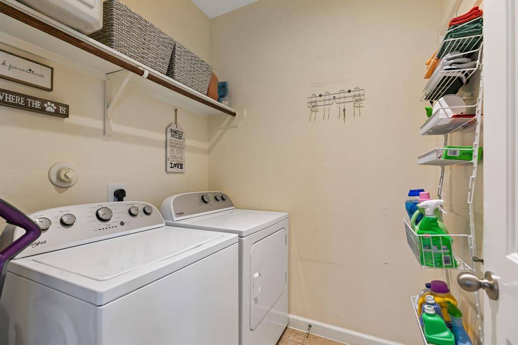 Utility room  for all your laundry chores.  Shelving above for storage organization.