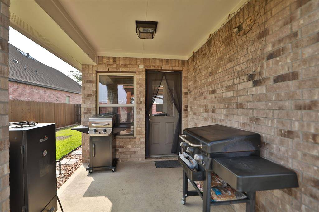 This covered patio features a brick exterior perfect place for entertaining or relaxing.