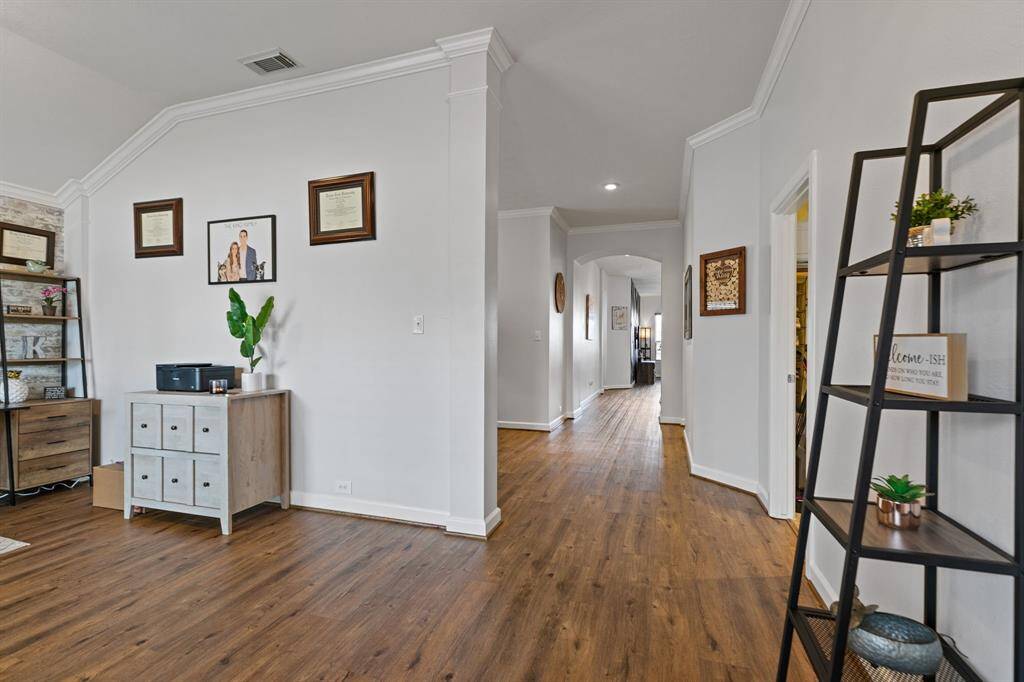 Welcome guests with elegance, featuring stunning laminate wood floors, crown molding, and soothing neutral paint tones.