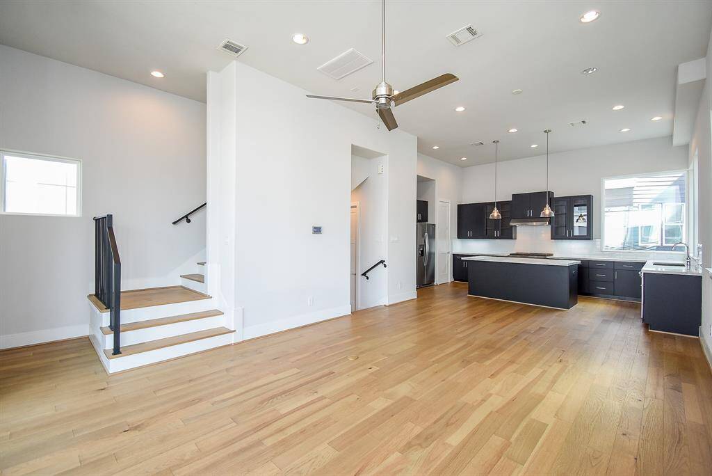 Walk into the second floor, and be mesmerized by this open floor plan. Highlighted by hardwood floors, recessed lighting, and a ceiling fan, this floor is the perfect entertainment space to spend time with family and friends.