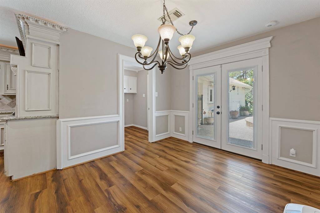 While dining, you can enjoy the inviting back yard through the lovely french doors.