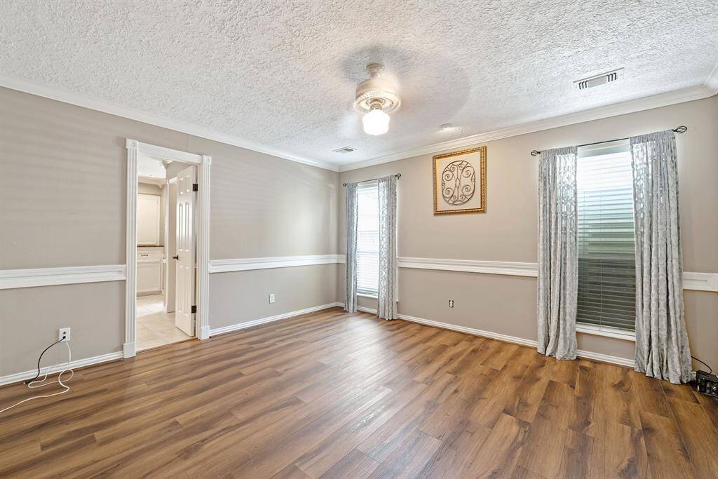 Retire at night to your luxurious downstairs primary suite boasting crown molding and chair rail.