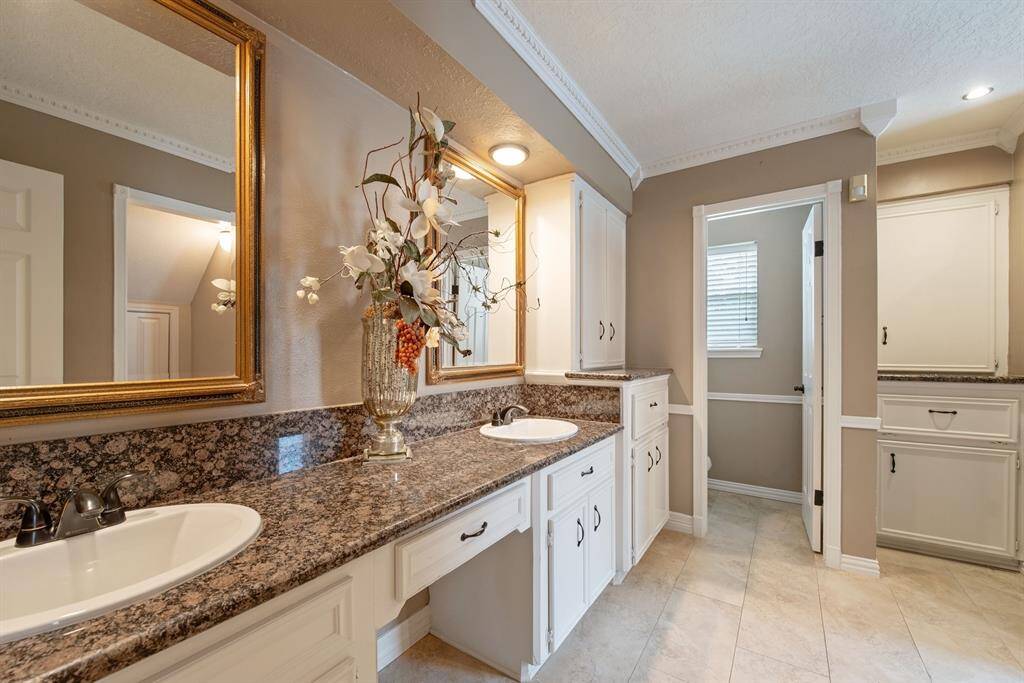 Beautifully redone primary bath has double sinks plus knee space and a private water closet.