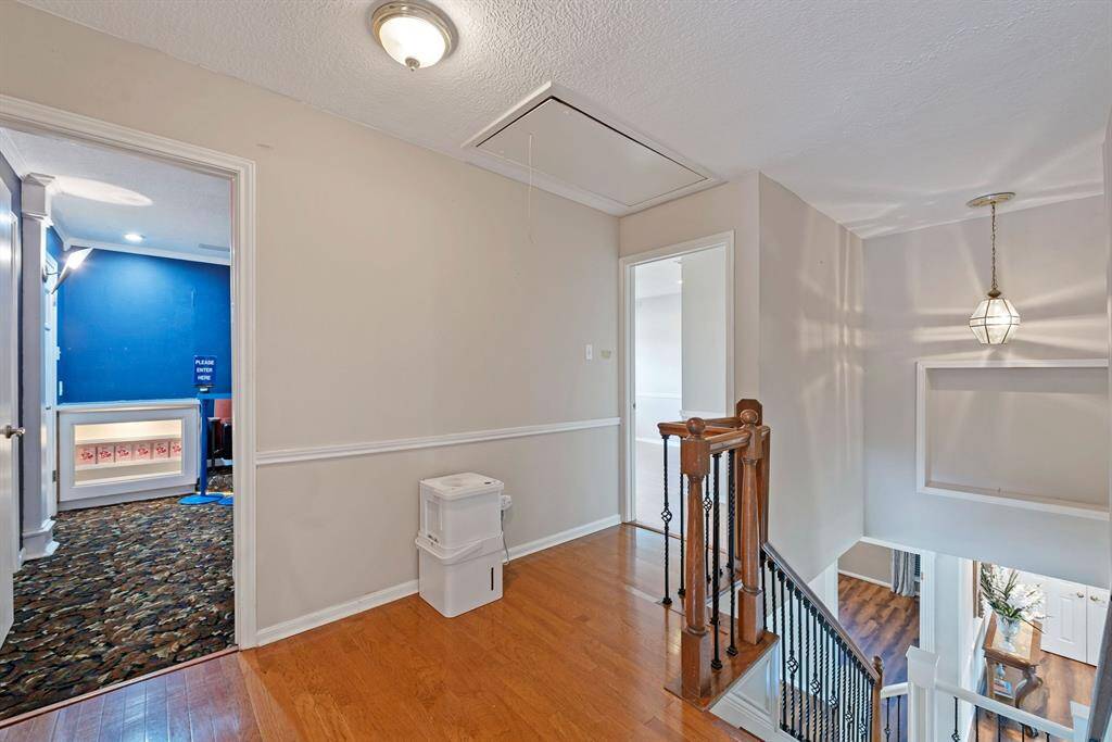 Open landing at the top of the stairs could be a reading nook or study area.
