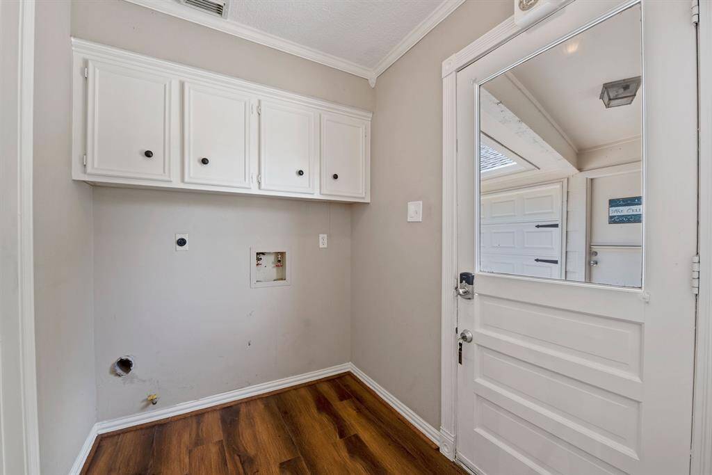 Utility room has access to back yard and garage for unloading groceries and more.
