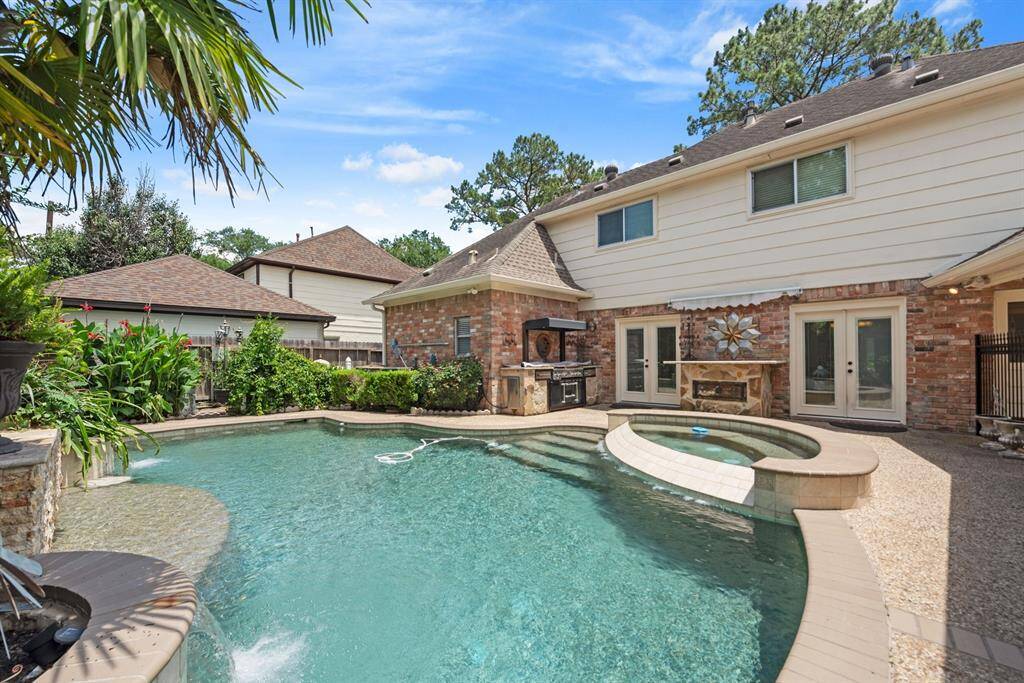 Step outside into this oasis!  Outdoor kitchen and serving area for your poolside enjoyment!