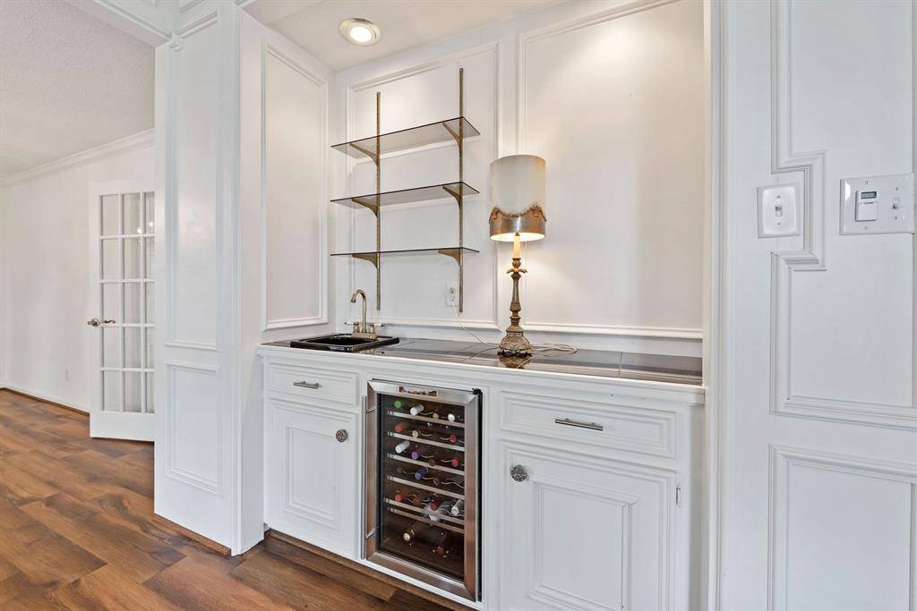Bar area has wine cooler and sink, plus ample storage for all of your serving ware.