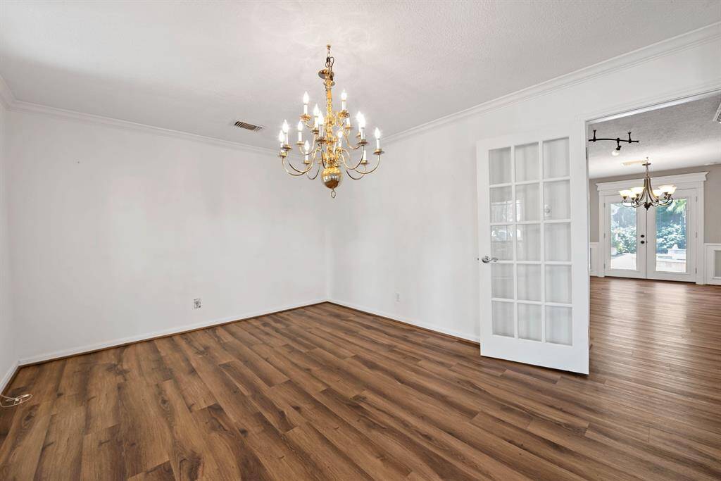Wood floors and crown molding add an upscale air to this dining room.  Dining room opens to kitchen for serving ease while entertaining.