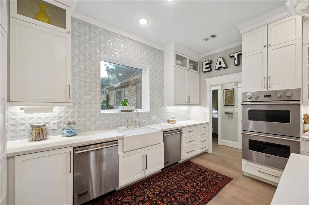 Truly a chef's KITCHEN complete with dual dishwashers, apron sink and designer back splash.