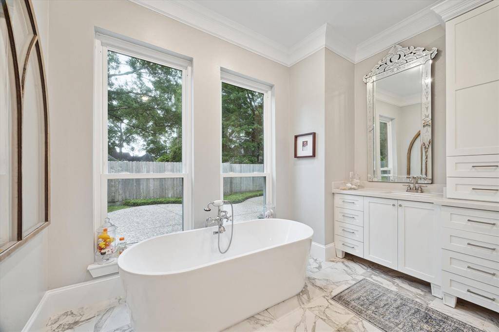 Another view of the stunning PRIMARY BATH overlooking the private back yard.