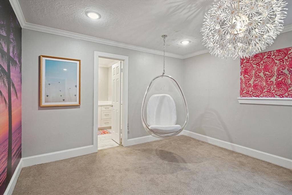 This SECONDARY BEDROOM overlooking the back yard with its playful chandelier, is every teenager's dream room.
