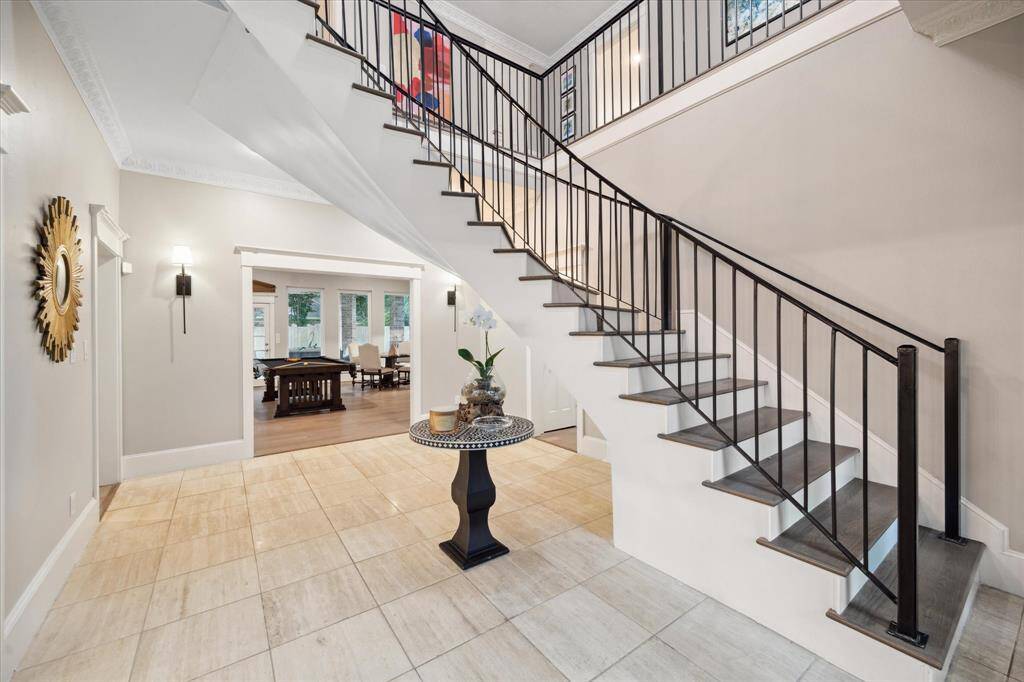 FRONT ENTRY with recently new sweeping staircase.