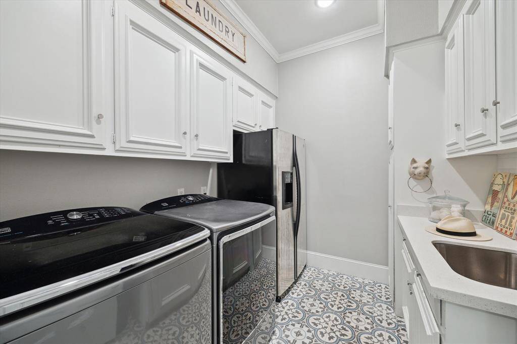Large UTILTIY ROOM offers plenty of cabinet space, sink and a second fridge that makes entertaining and catering extra convenient.