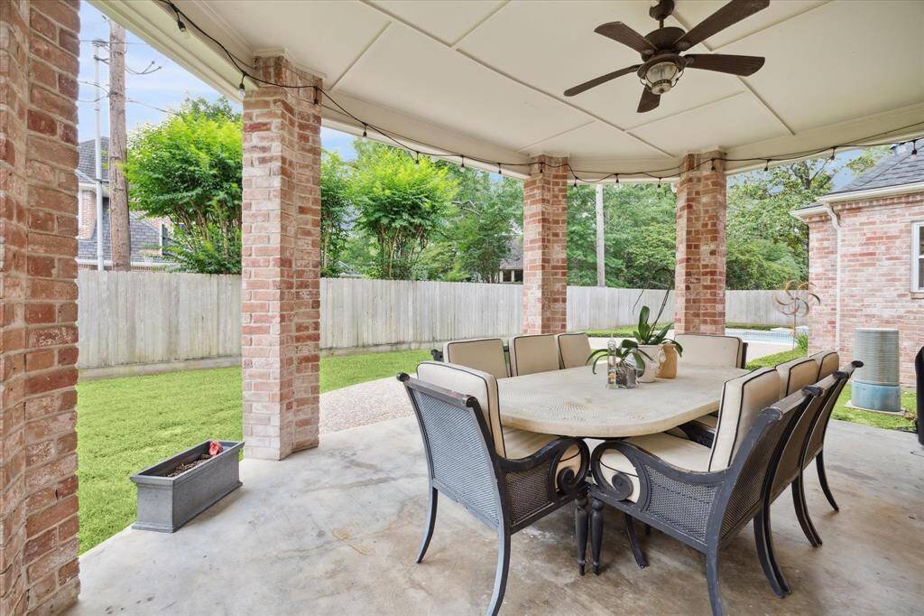 COVERED PATIO just off the gameroom overlooks part of the back yard and is the perfect spot for dining al fresco or enjoying an outside game night!