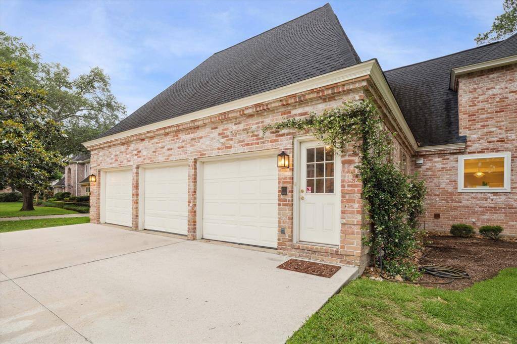 Attached THREE CAR GARAGE offers overhead storage racks and additional side storage and is located on the side of the house not obstructing the beautiful front elevation of the home.