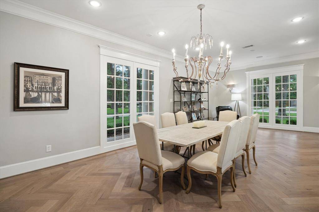 Elegant DINING ROOM off the front entry is large enough to host numerous guests with additional space at the opposite end for a sitting area or the room could be divided to provide a separate breakfast room off the kitchen.