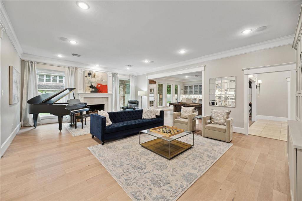 The comfortable LIVING ROOM nestled between the gameroom and kitchen is a perfect gathering place with its cozy fireplace anchoring the room.