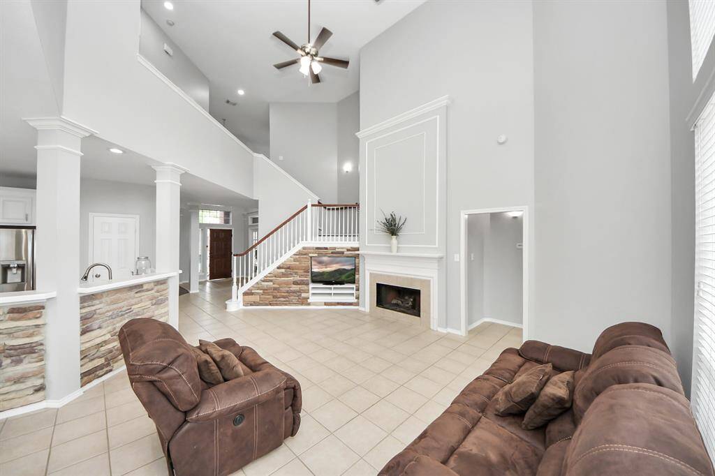 Over the gas-log fireplace, large picture frame molding frames the hearth beautifully, adding sophistication and character to the focal point of the room.