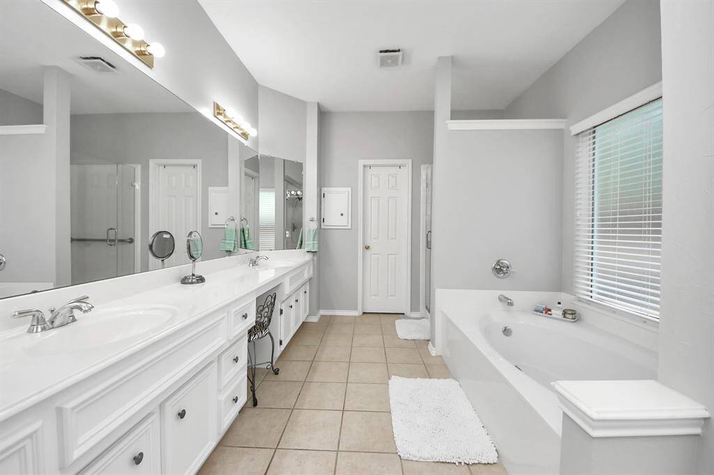 In the private ensuite bathroom, be in awe of the expansive countertop, providing generous space for all your essentials.