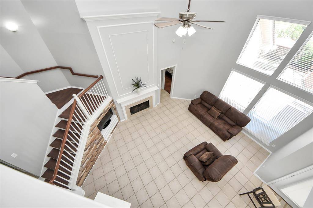 From the second floor, take in the impressive view of the family room below, where the open layout and soaring ceilings create a sense of grandeur and connection between the levels.
