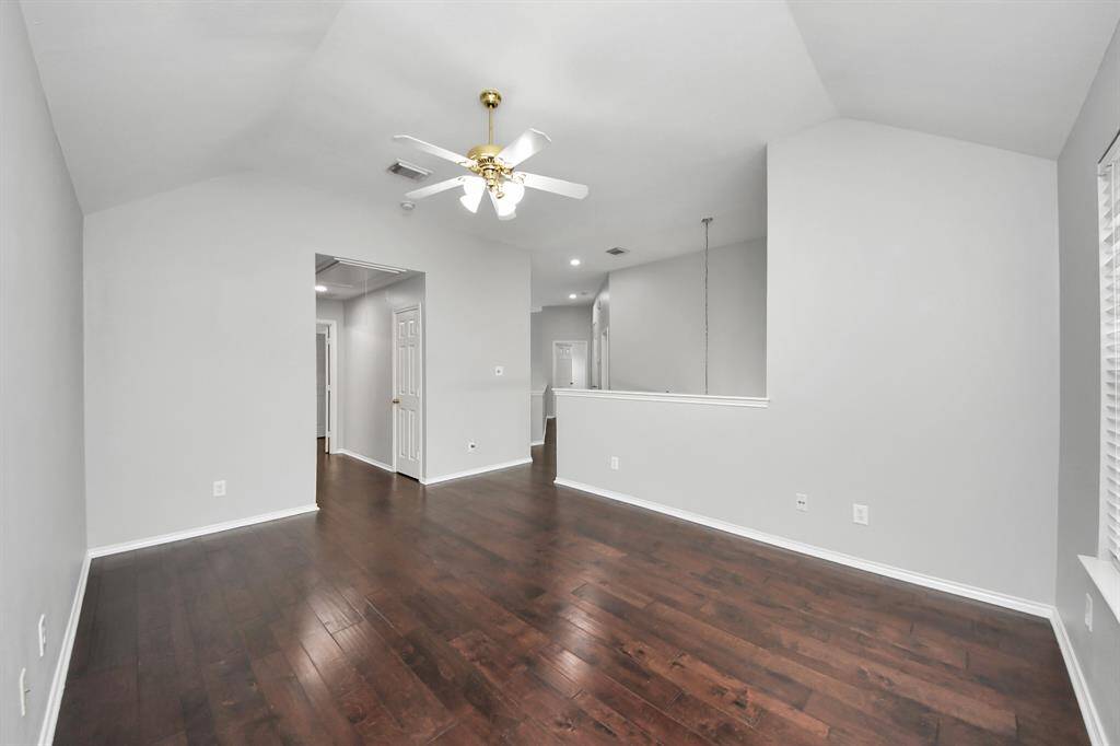 The high ceiling, paired with a ceiling fan, enhances the game room’s openness and airflow, creating a comfortable, airy feel. Whether used for family movie nights, game time, or as a versatile play area, this room offers endless possibilities.