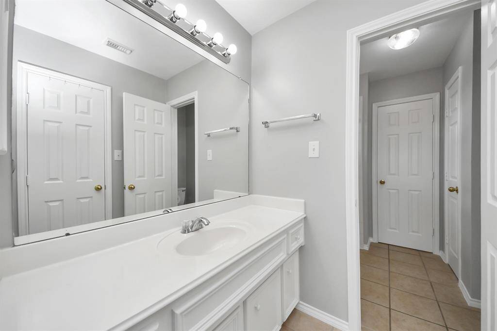 The tub/shower combo is thoughtfully positioned to separate the two sink areas, offering a practical and functional layout for shared use while maintaining privacy.